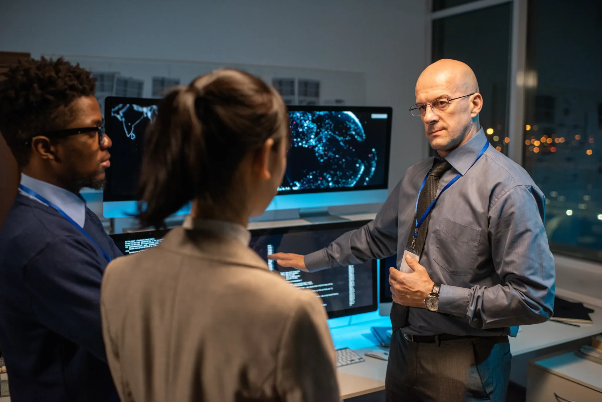 Professionals discussing data analysis in a tech office setting.